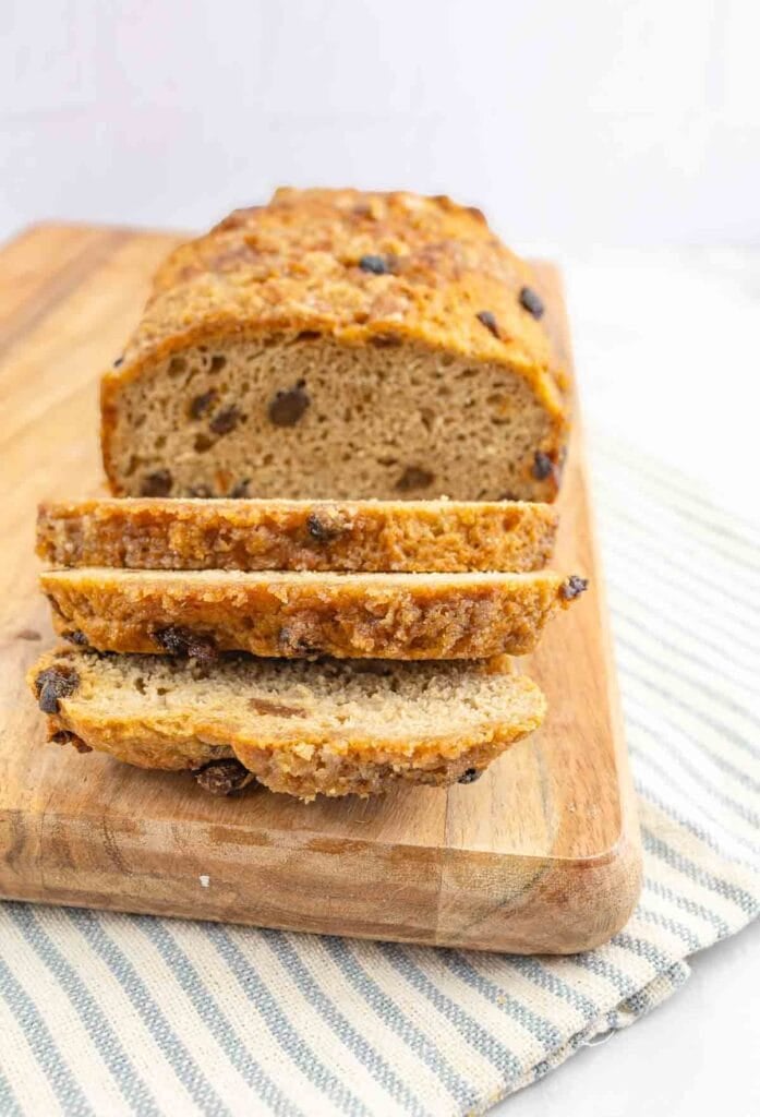 a loaf of cinnamon raisin bread with part of the loaf sliced.