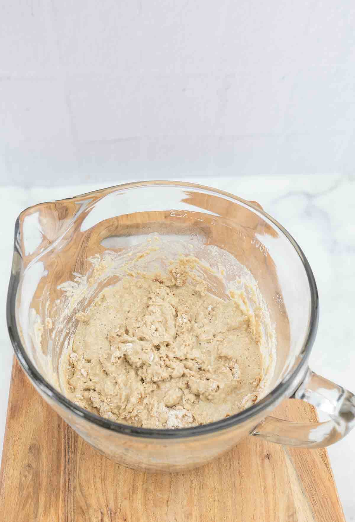 cinnamon bread dough resting in large mixing bowl.