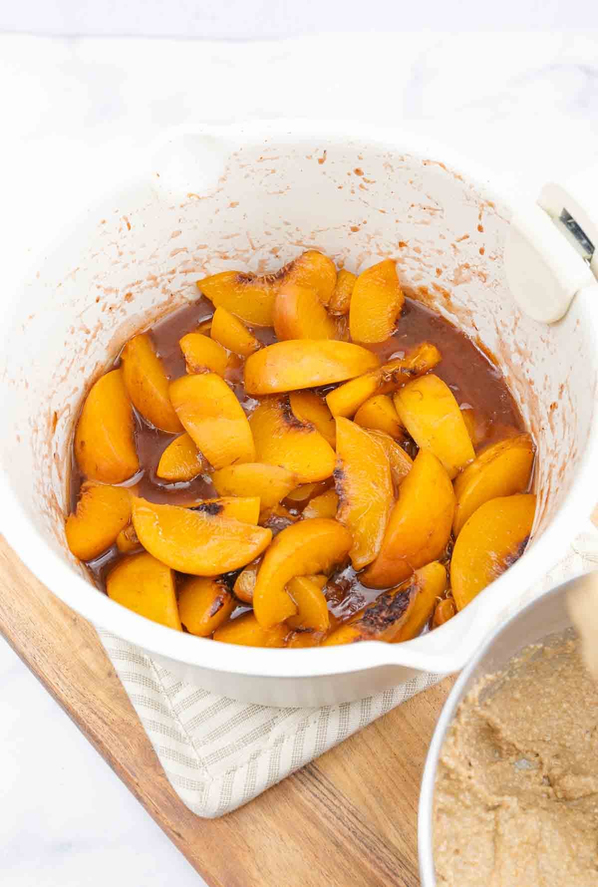 bowl of cooked peaches with spices.