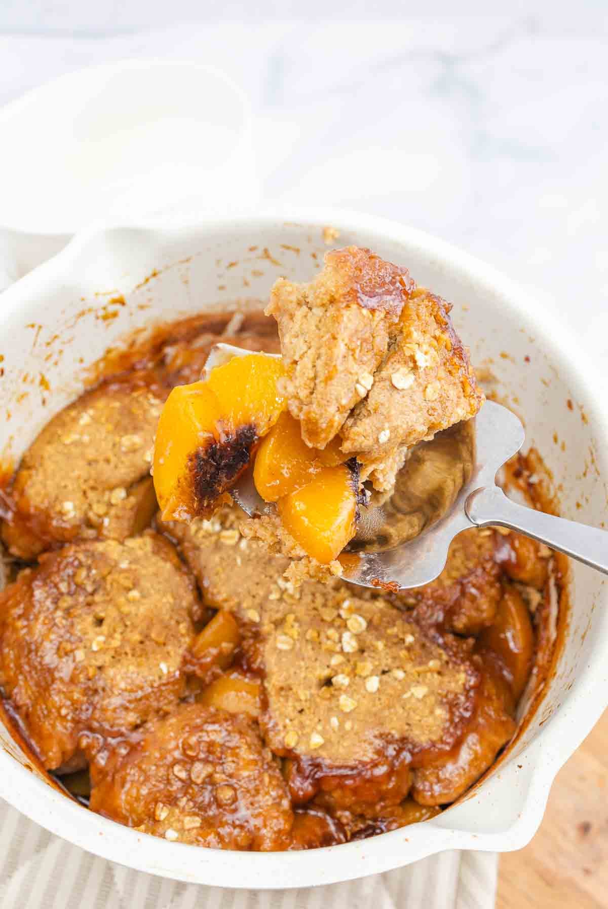 baking dish of vegan peach cobbler.